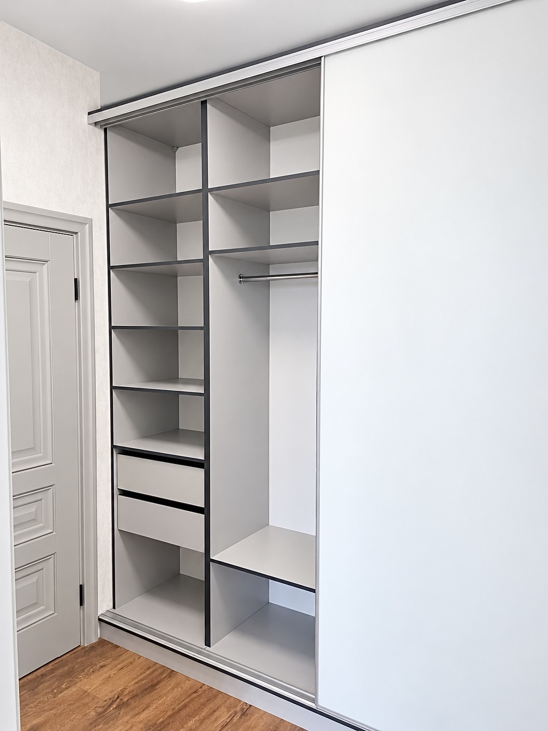 Open cabinet with shelves and a matte white door